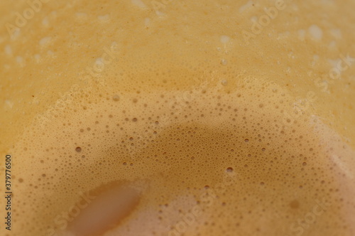 Abstract background - foam after coffee with milk, close-up inside the cup
