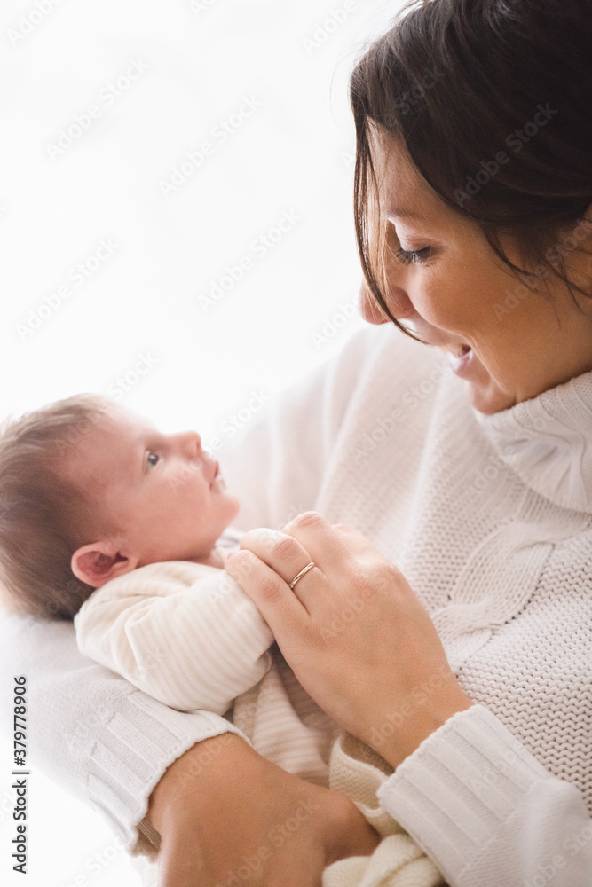 Smiling mother holding baby