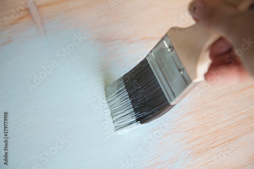 close up of painting plywood with a brush