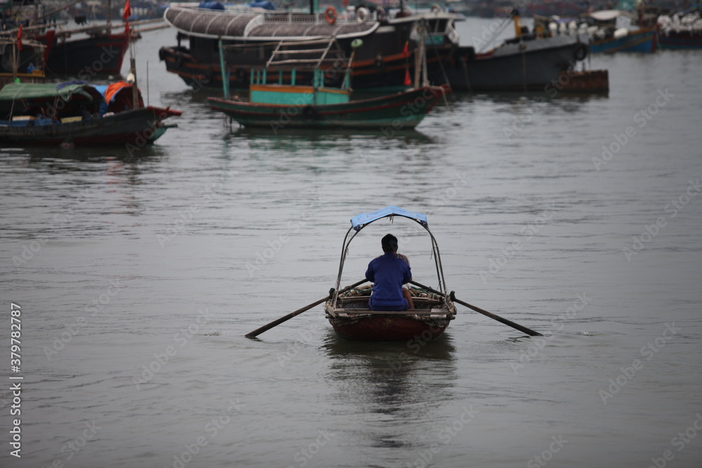 Obraz premium Floating Fishing Village In The Ha Long Bay. Cat Ba Island, Vietnam Asia. Cat Ba, Vietnam - March 5, 2020