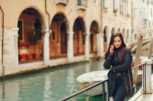 girl talking on the phone and taking pictures in Venice Italy © prostooleh