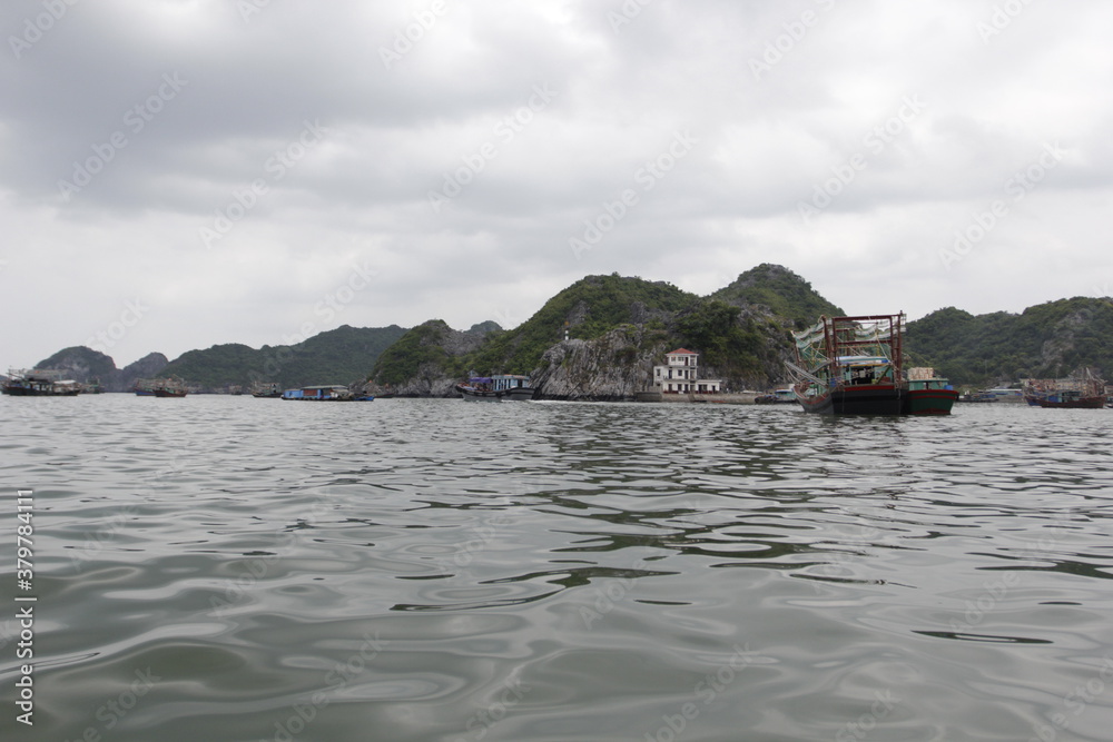HA LONG BAY, VIETNAM - March 13, 2020: Halong Bay, Vietnam. Unesco World Heritage Site. Traditional tourist boats. HA LONG BAY, VIETNAM - March 13, 2020: Halong Bay, Vietnam. Unesco World Heritage Site. Traditional tourist boats.