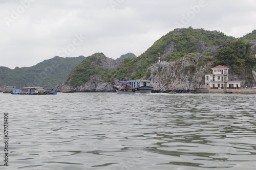 HA LONG BAY, VIETNAM - March 13, 2020: Halong Bay, Vietnam. Unesco World Heritage Site. Traditional tourist boats. © binhdd
