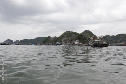 HA LONG BAY, VIETNAM - March 13, 2020: Halong Bay, Vietnam. Unesco World Heritage Site. Traditional tourist boats.