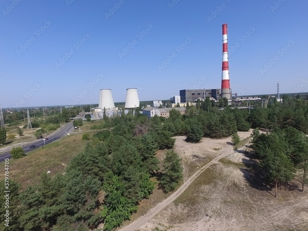 Chimney of power plant in the forest. Drone aerial view. Near Kiev,Ukraine Chimney of power plant in the forest. Drone aerial view. Near Kiev,Ukraine