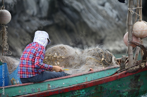 Cat Ba Island, Vietnam -2019-06-19: Cat Ba Island, Vietnam -2019-06-19: Central Market, fruit and vegetable vendors, seafood and meat, woman sells seafood, crabs, fish photo