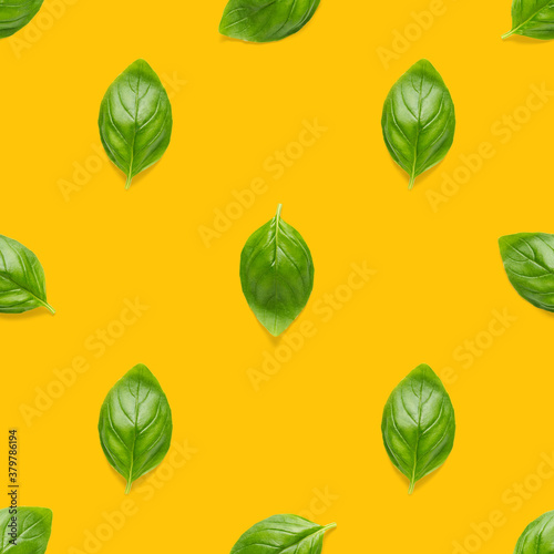 Italian Basil leaf herb seamless pattern on orange background, Creative seamless pattern made from fresh green basil flat lay layout.