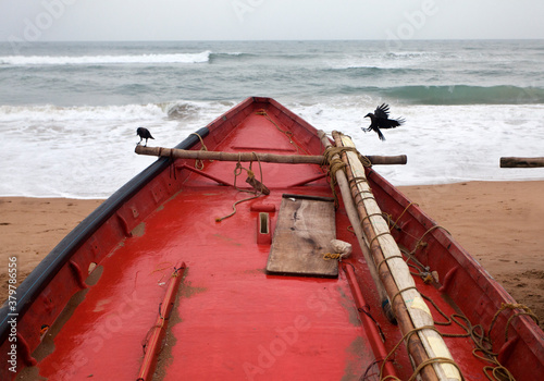 A crow is landing on a fisherman boat