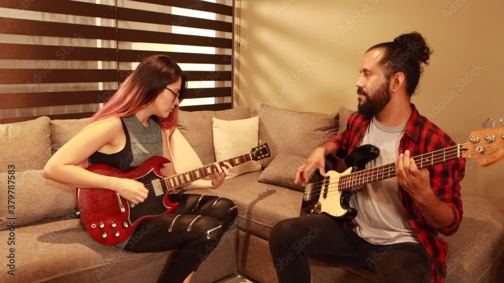 Pareja joven latina mexicana tocando musica juntos en sala