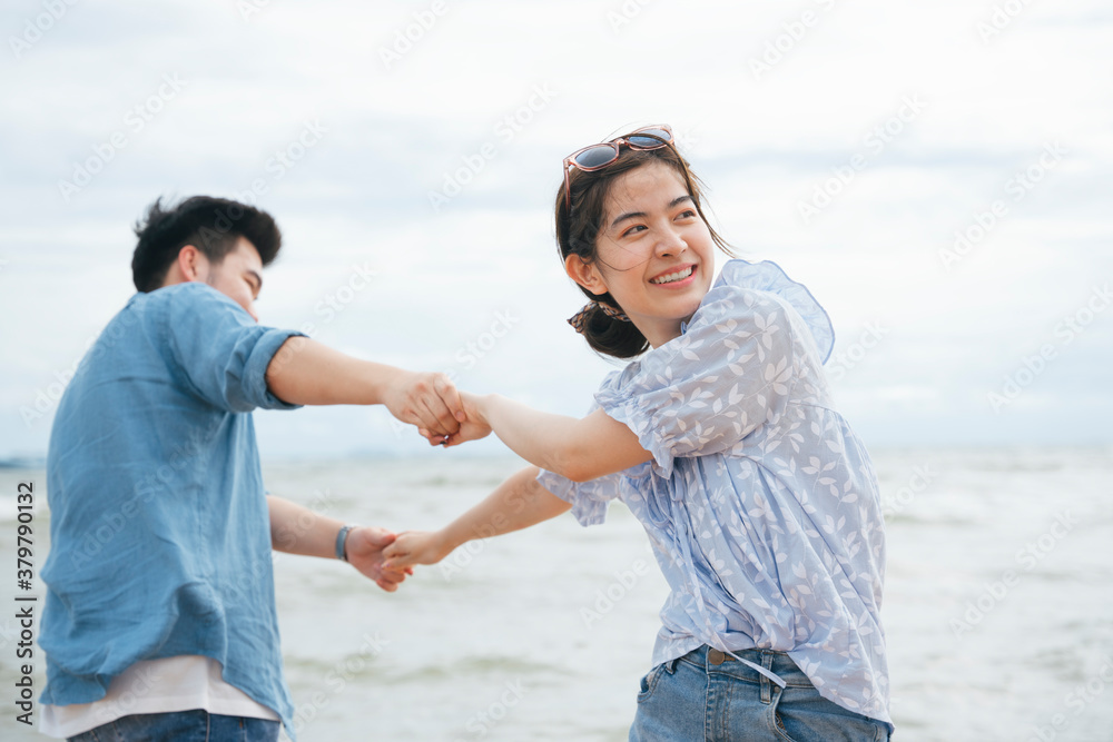 Happy romantic asian couple traveler holding hands dance on the beach. Happy romantic asian couple traveler holding hands dance on the beach.