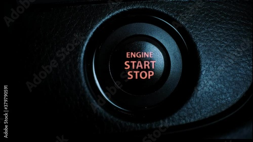 Hand press the button to start stop the car engine, Starting car engine. Close up.