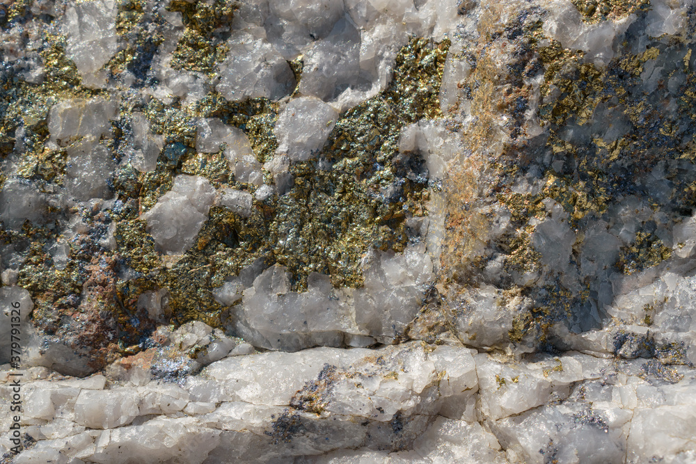 Molybdenite ore in granite. Minerals - molybdenite, pyrite, chalcopyrite, white quartz. Sorskoe deposit, Khakassia, Russia. Concept of mining useful metal - molybdenum. Selective focus.