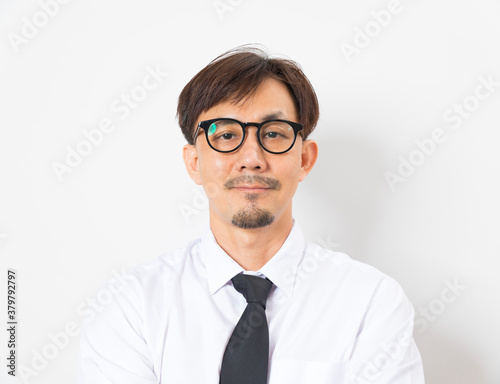 A good looking young asian businessman wearing white shirt  and tie standing over white background with happy smile.