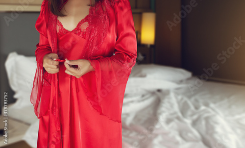 Canvastavla Women wearing red nightgown & long sleeve satin robe with floral lace, A girl trying on new white nightwear for sleep