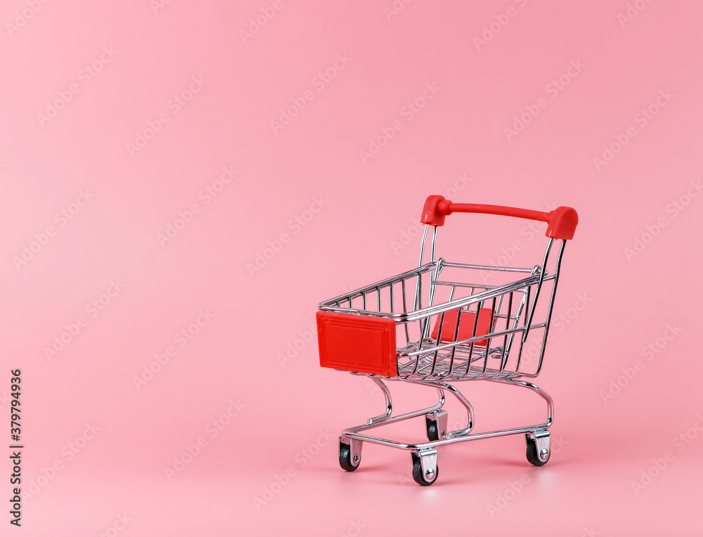 empty shopping cart on pink background with copy space. empty shopping cart on pink background with copy space.