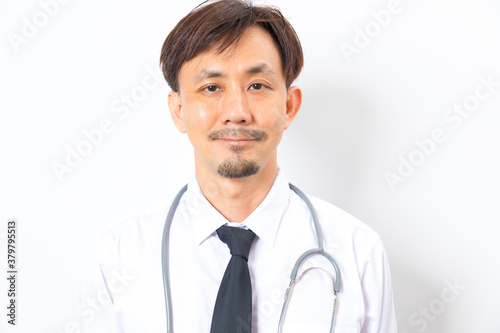 Headshot of handsome Asian man doctor diagnose with stethoscope on white background.