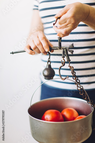 Woman holding a antique rusty scale