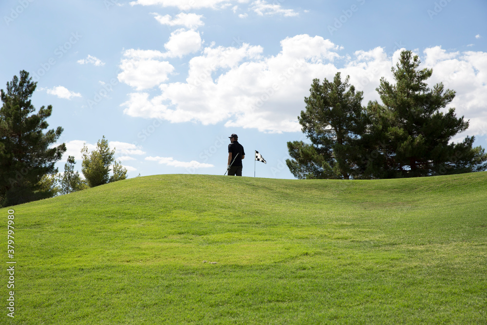 Man next to pin on putting green