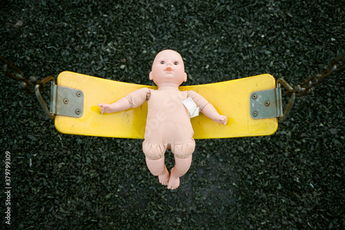 creepy doll on swing photo