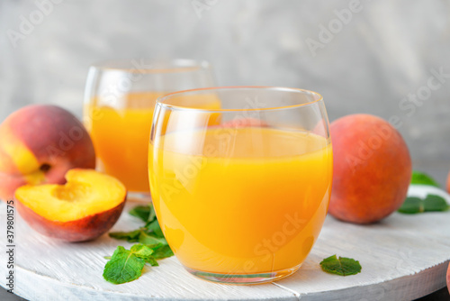 Glasses of fresh peach juice on table