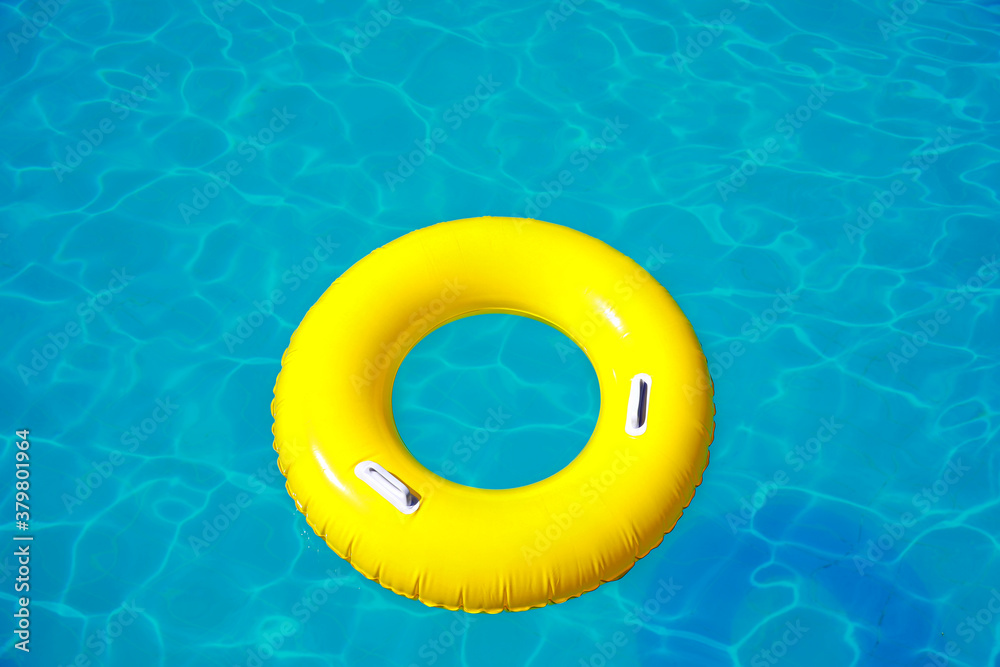 Yellow inflatable ring in swimming pool Yellow inflatable ring in swimming pool