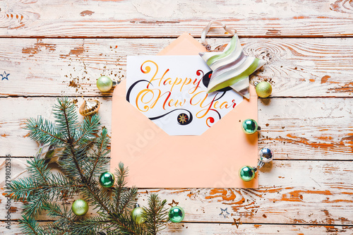 Beautiful composition with New Year greeting card on wooden background