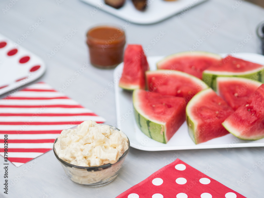 Potato salad and watermelon on table for bbq Potato salad and watermelon on table for bbq