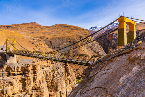 Фотография Chicham bridge is suspension stiffened steel truss bridge at altitude of 4145m over 1000 feet gorge of 'samba lamba' rivulet connecting Chicham & kibber villages in Spiti valley of Himachal Pradesh