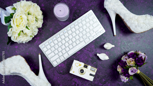 Photo Wedding bridal theme desktop workspace with high heel shoes, bouquets and accessories on vintage purple textured background