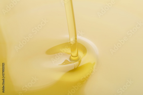 Pouring of fresh olive oil, closeup