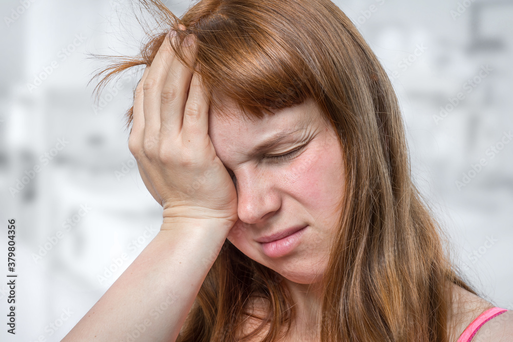 Woman with eyes pain is holding her aching eye Woman with eyes pain is holding her aching eye
