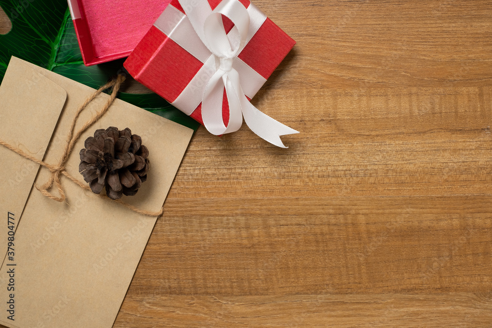 Desk with red gift on wooden table top view. Desk with red gift on wooden table top view.