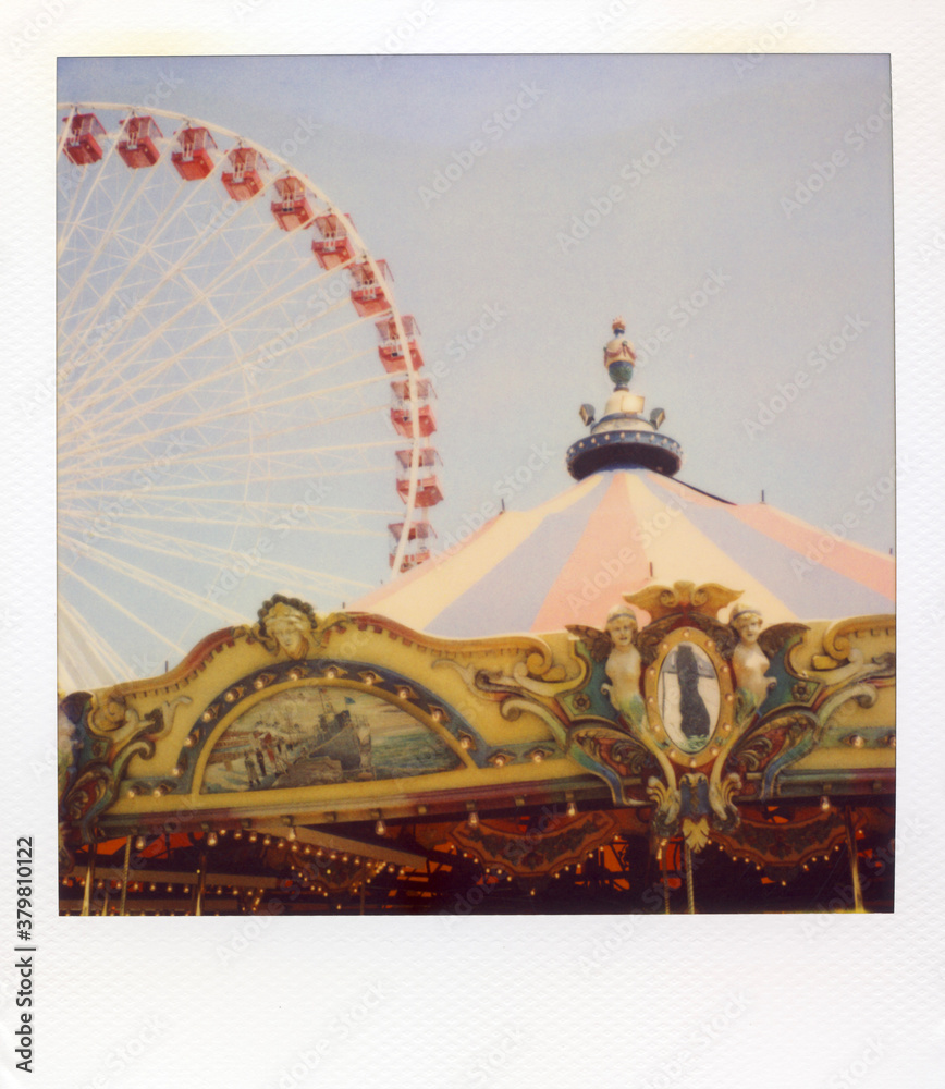 A Carousel And Ferris Wheel Photographed With Expired Polaroid Film Stock  Photo | Adobe Stock