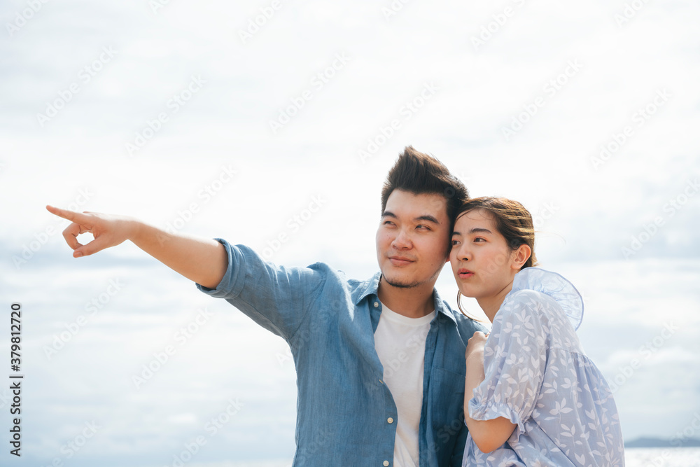 Couple traveler on the beach with pointing gesture. Couple traveler on the beach with pointing gesture.