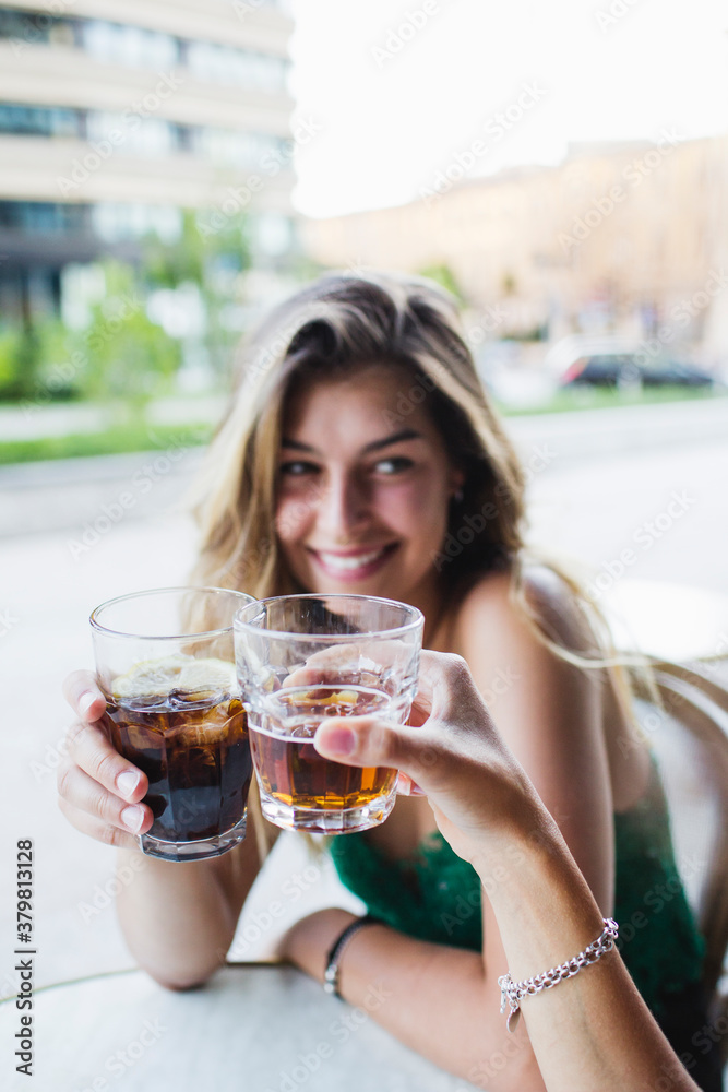 Two girls drinking together at the bar Two girls drinking together at the bar