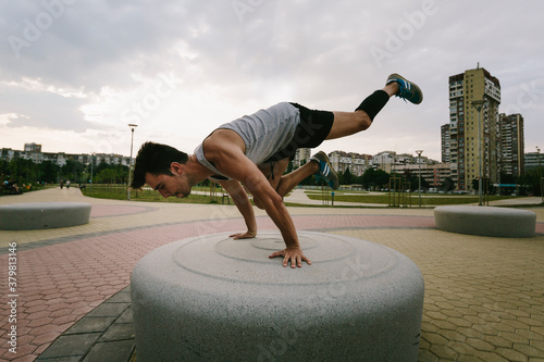 Young athletic man working out in urban environment