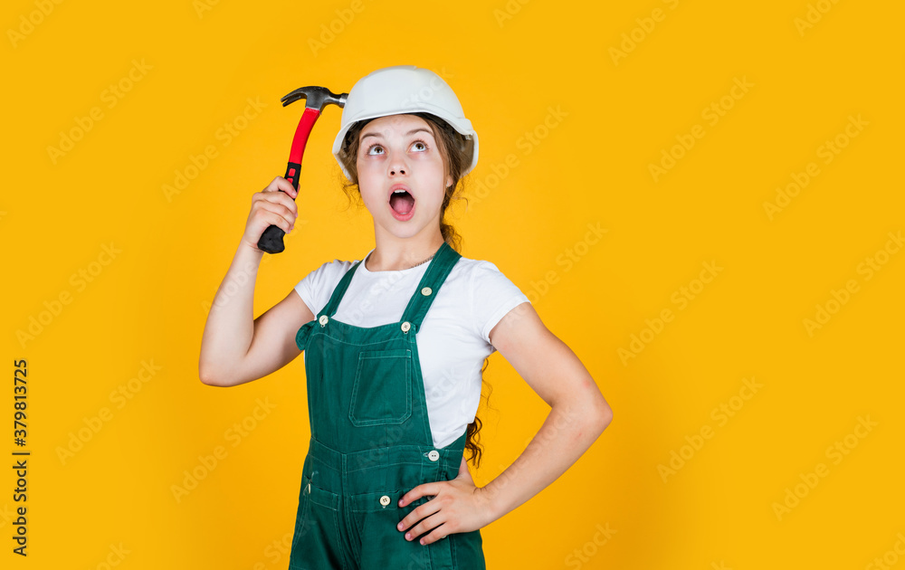 oh my god. hammering. she is good assistant. Kid engineer with carpenter work hammer. Labor day at 1 may. little girl in hard hat holds hammer. best repairer ever. learning to use hammer