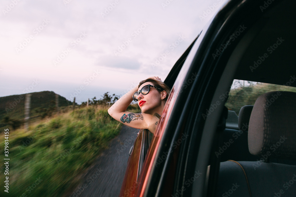 woman getting the head out of the car window woman getting the head out of the car window