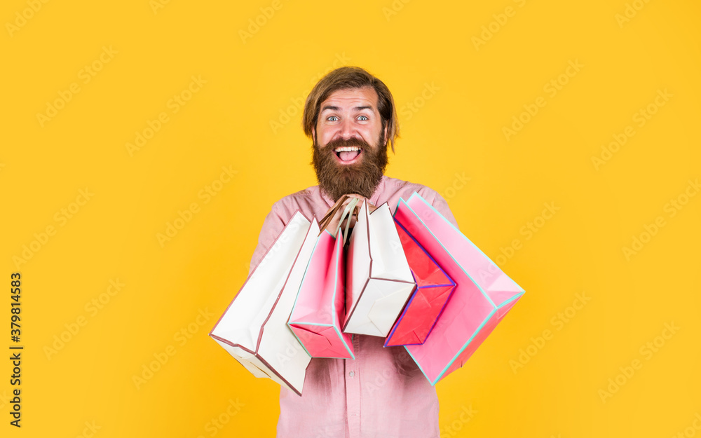 In shopping store. best sale offer. happy bearded man with present pack. cheerful brutal hipster hold gift. paper shopping bag. birthday surprise at party. man with package. prepare for holidays In shopping store. best sale offer. happy bearded man with present pack. cheerful brutal hipster hold gift. paper shopping bag. birthday surprise at party. man with package. prepare for holidays
