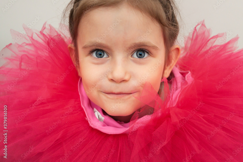 Portrait of a Little Girl in a funny ballet skirt dressed around the neck
