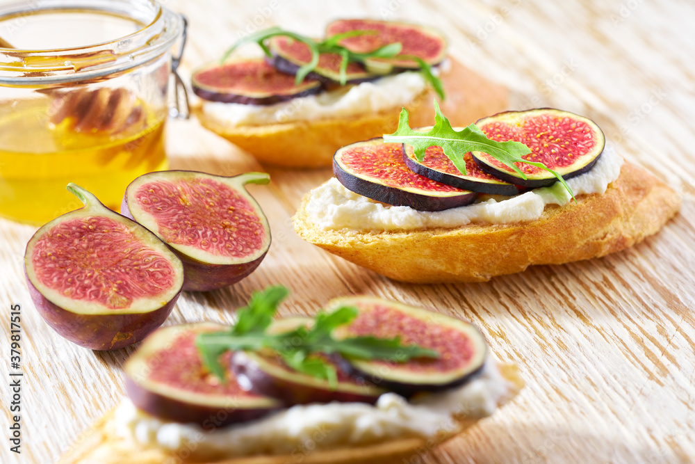 Bread snack with soft white cheese and figs. Healthy vegetarian appetizer. Bread snack with soft white cheese and figs. Healthy vegetarian appetizer.