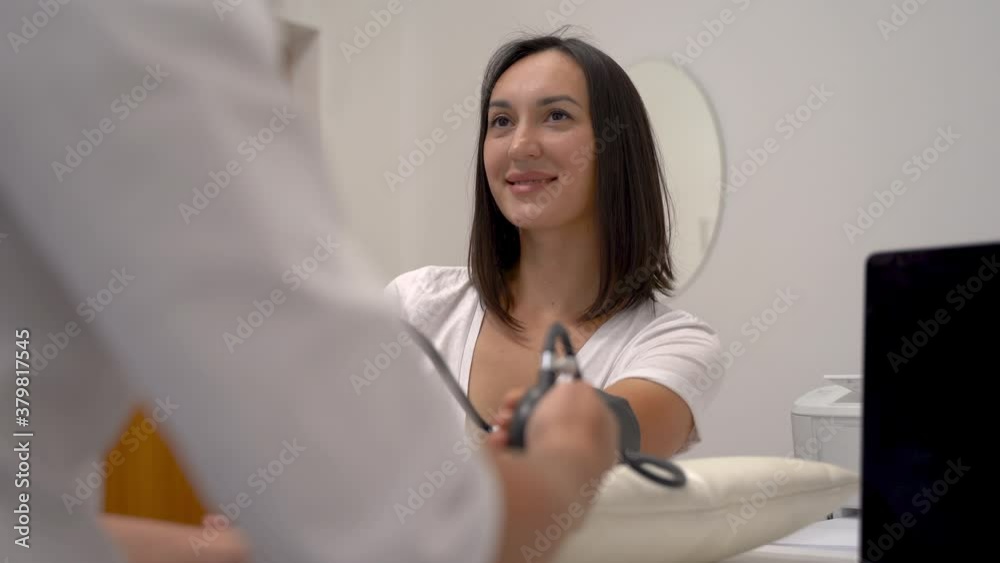 Blood pressure measurement of a woman. Portrait of female patient.
