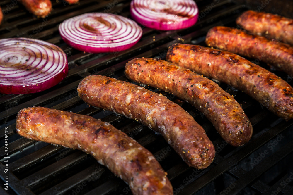Bratwurst, Kielbasa and red onion on the grill Bratwurst, Kielbasa and red onion on the grill