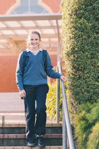 new high school student salking down the stairs on the school gr photo