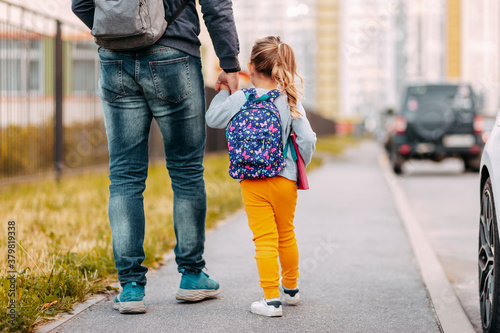 Father and daughter going to school for the first time. Back to school after pandemic.