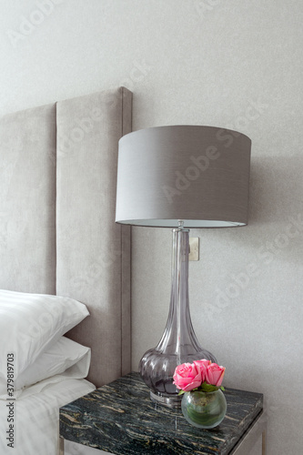 Contemporary bedside with table and tablelamp photo