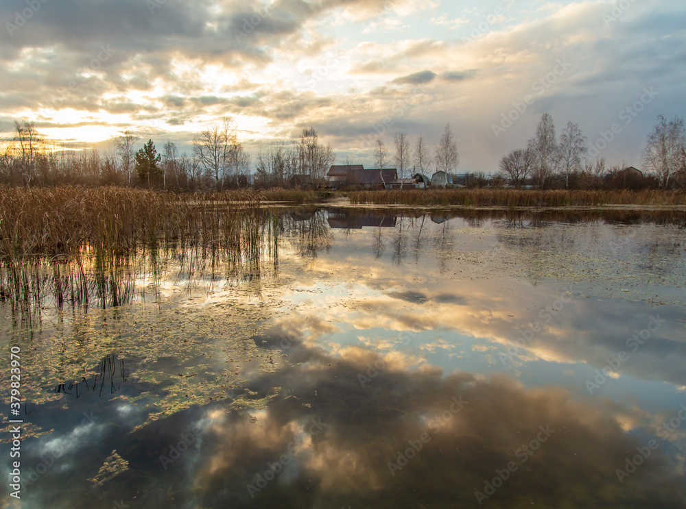 Clouds in the sky with reflection in the lake at sunset. Clouds in the sky with reflection in the lake at sunset.