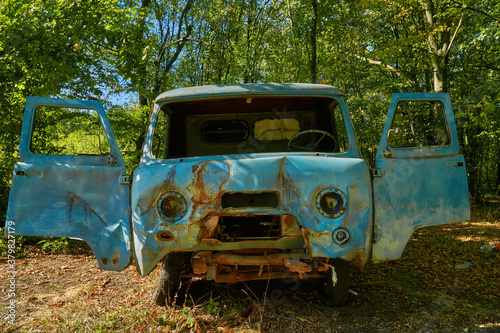 Abandoned old deterioration car in the autumn forest