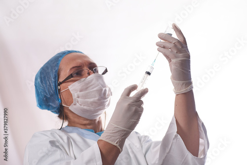The doctor gets the vaccine into the syringe. Glass bottle in a technician's hand. A bottle with a cure holds a hand in silicone gloves. A breakthrough in treatment. Vaccine medical exams. Pandemic.