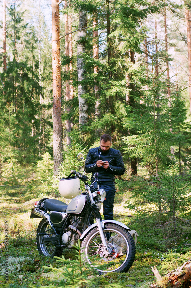 Biker checking route with his smartphone Biker checking route with his smartphone